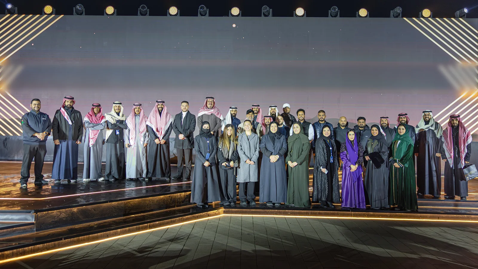 An OMQ on-site group photograph from the company profile.