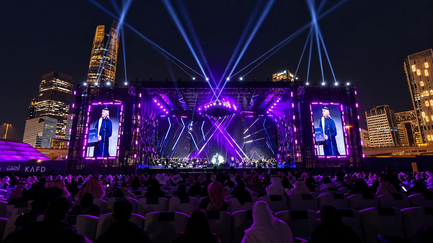 A live performance framed by KAFD’s skyline. AI-treated image.